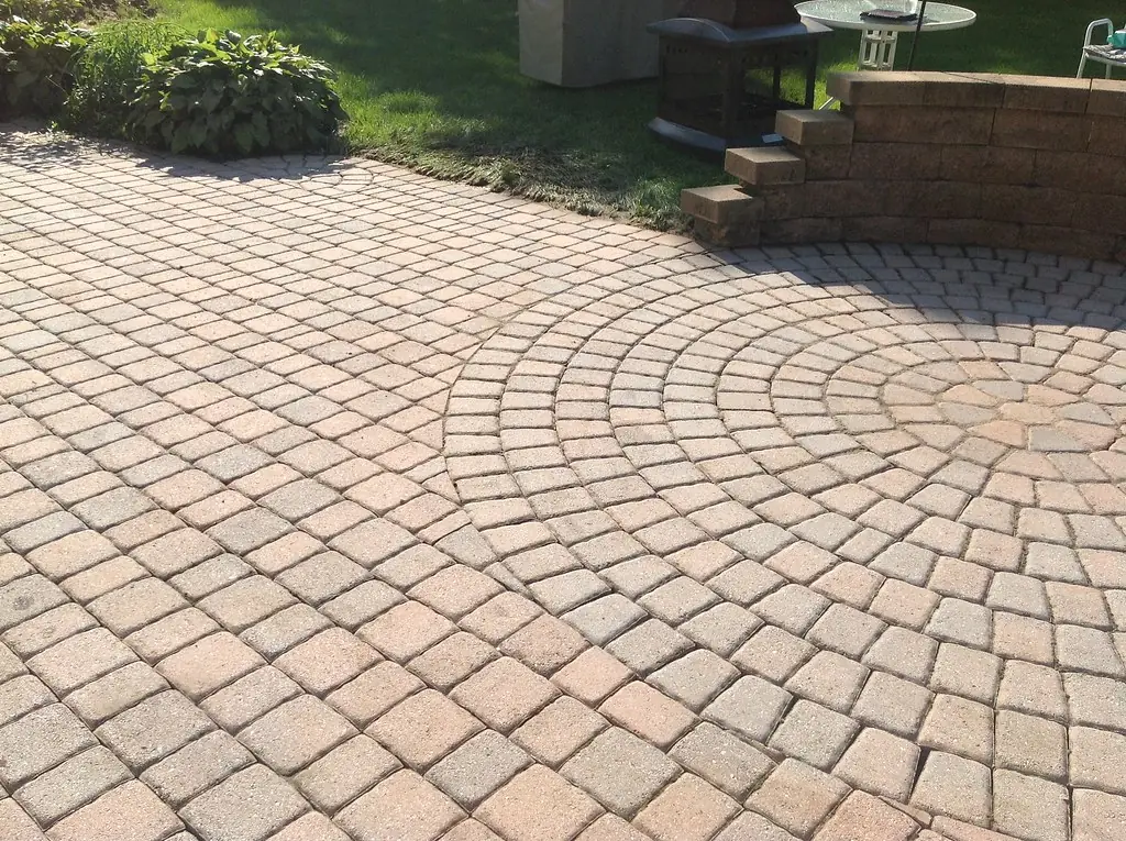 Concrete paver patio laid in a circle pattern with sanded joints, ready for paver sealing
